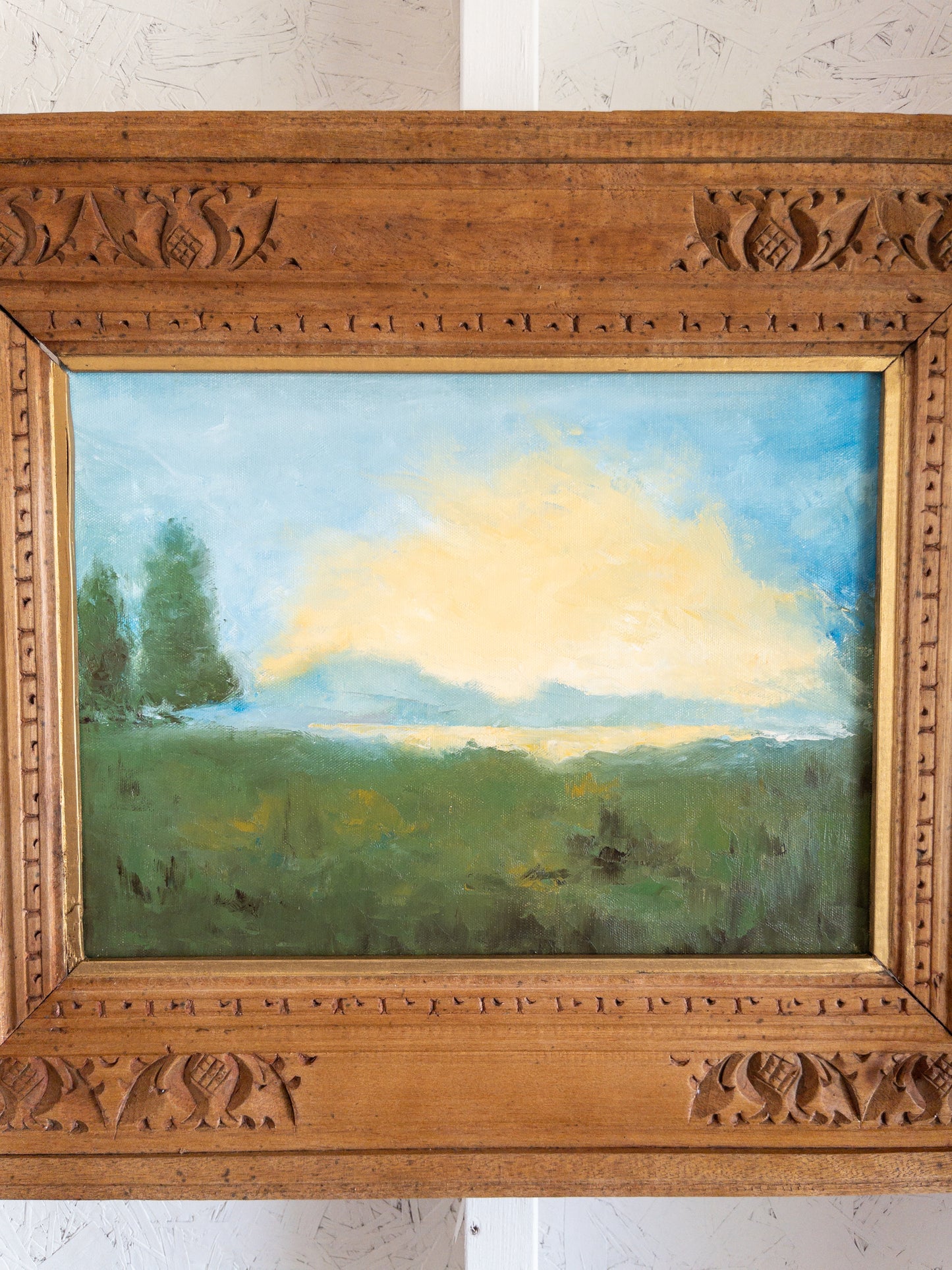 landscape painting in hand carved frame