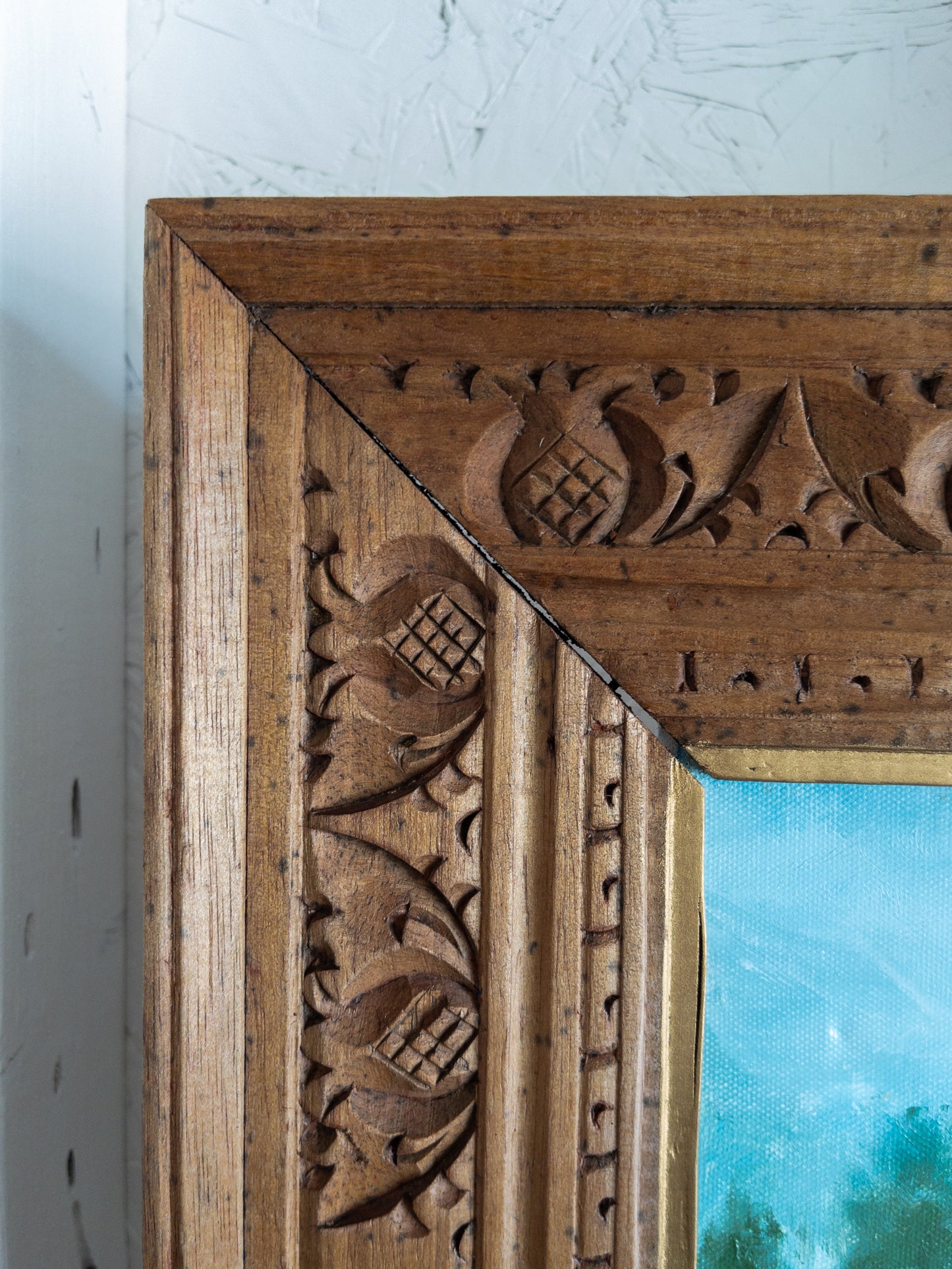 landscape painting in hand carved frame