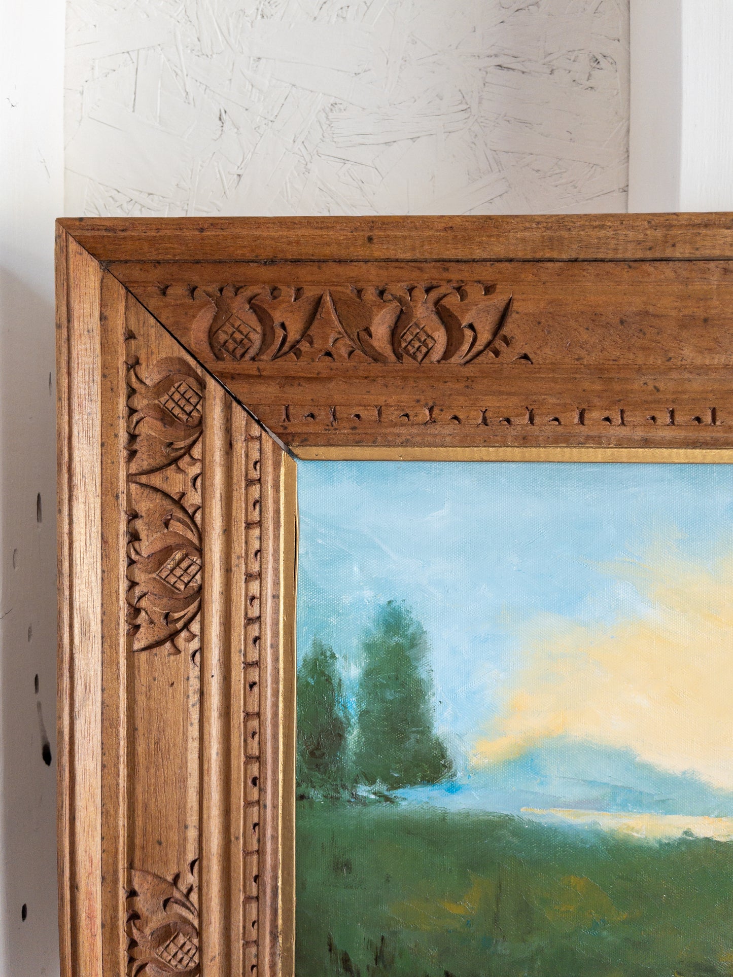 landscape painting in hand carved frame