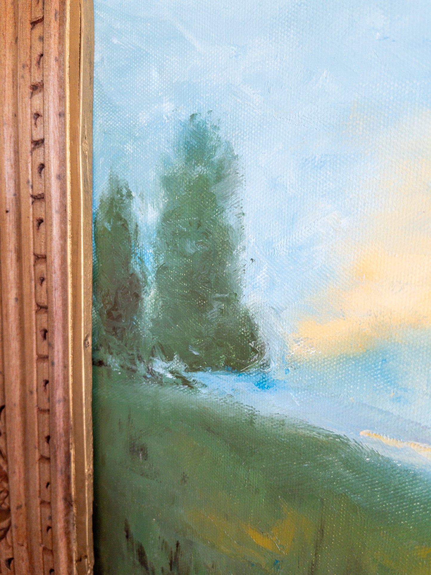 landscape painting in hand carved frame
