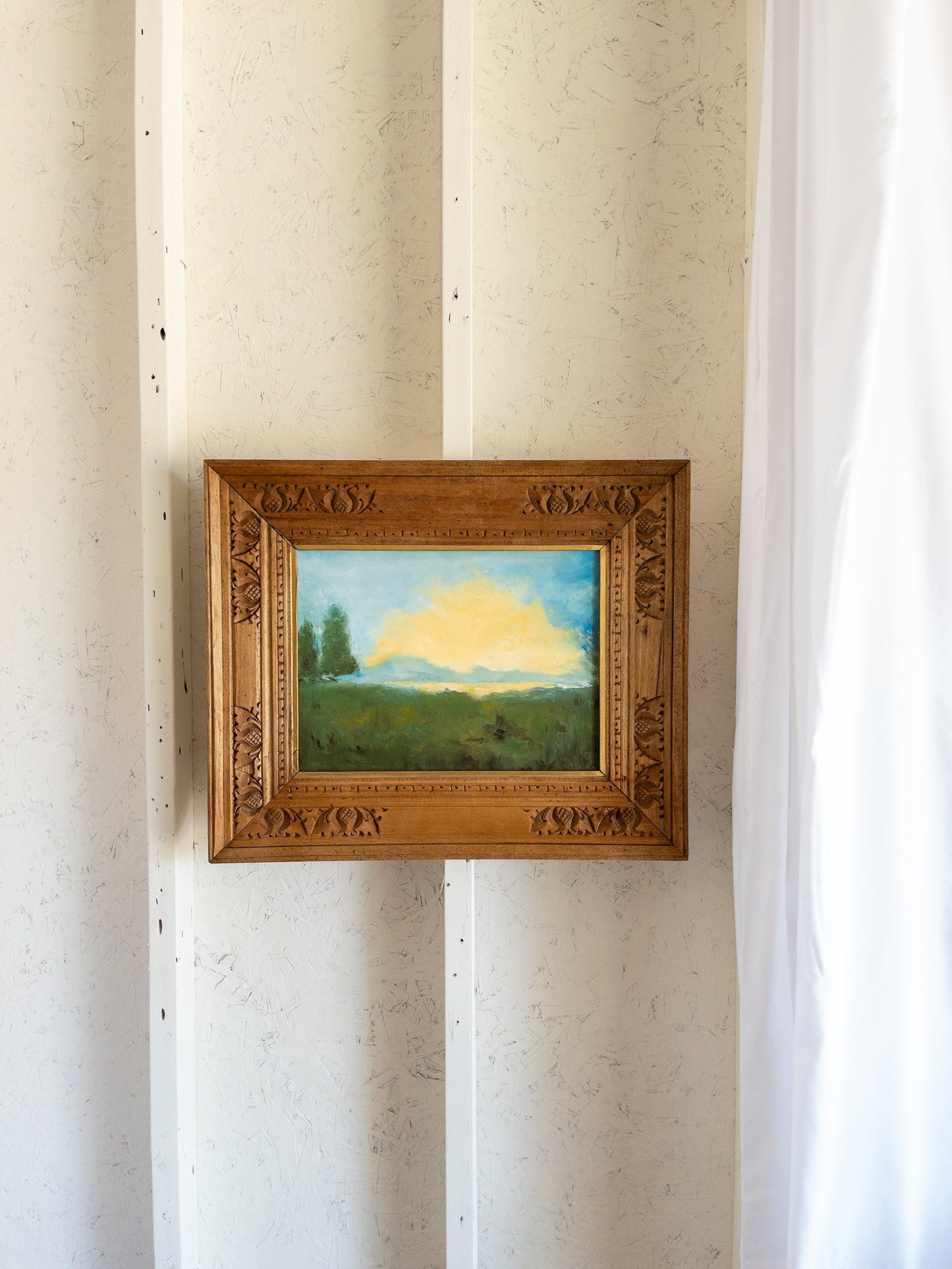 landscape painting in hand carved frame