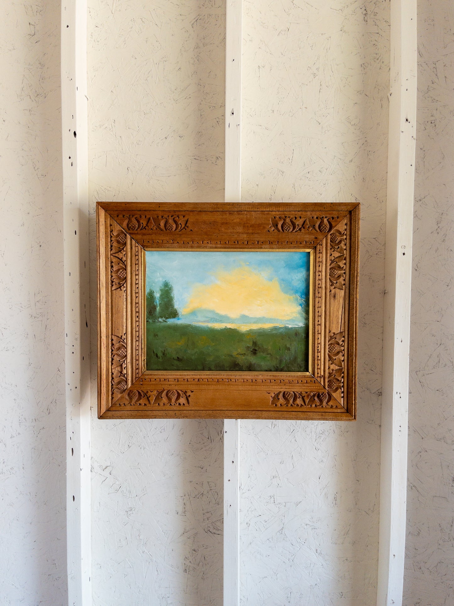 landscape painting in hand carved frame