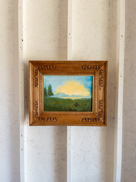 landscape painting in hand carved frame