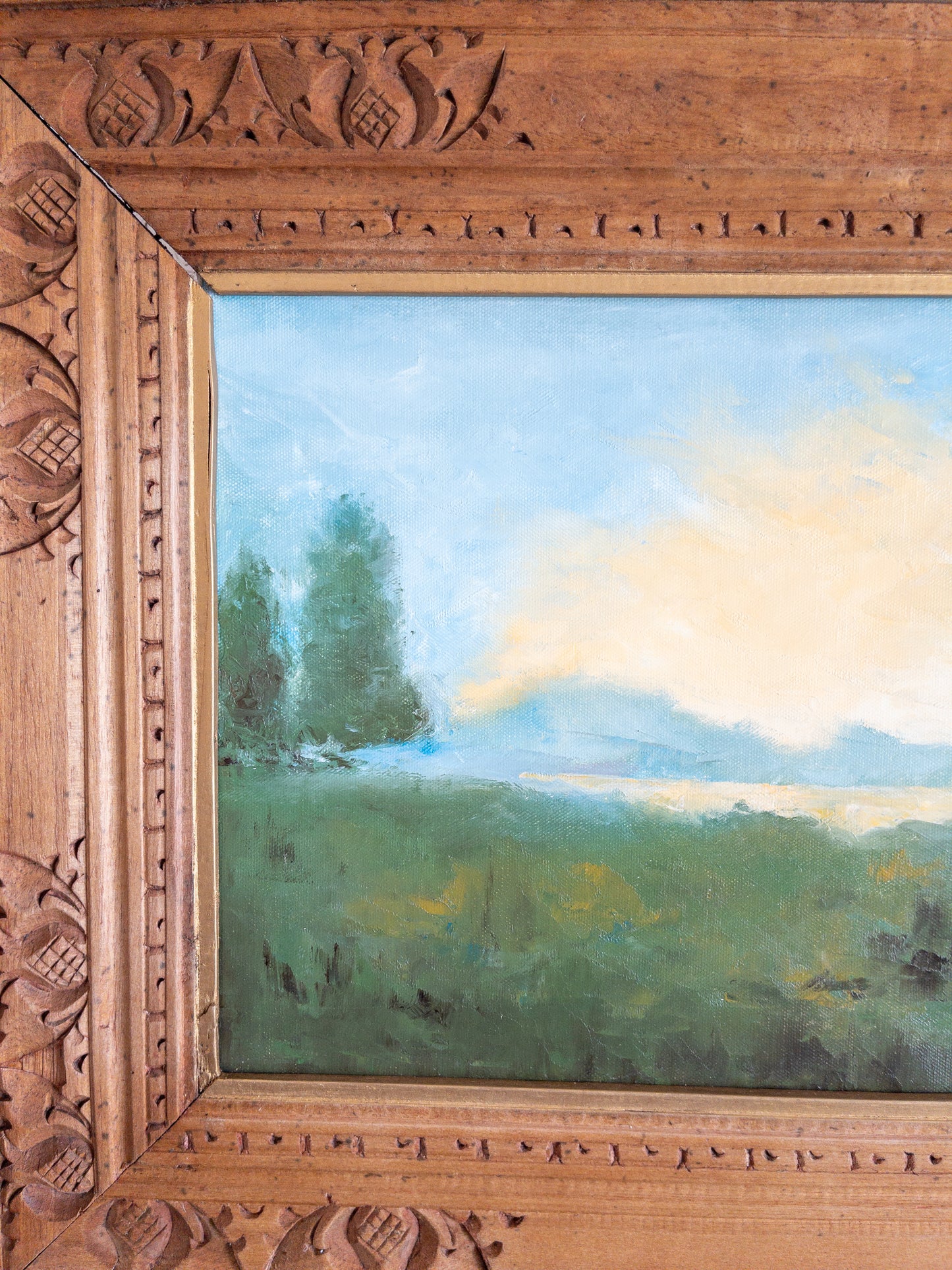 landscape painting in hand carved frame