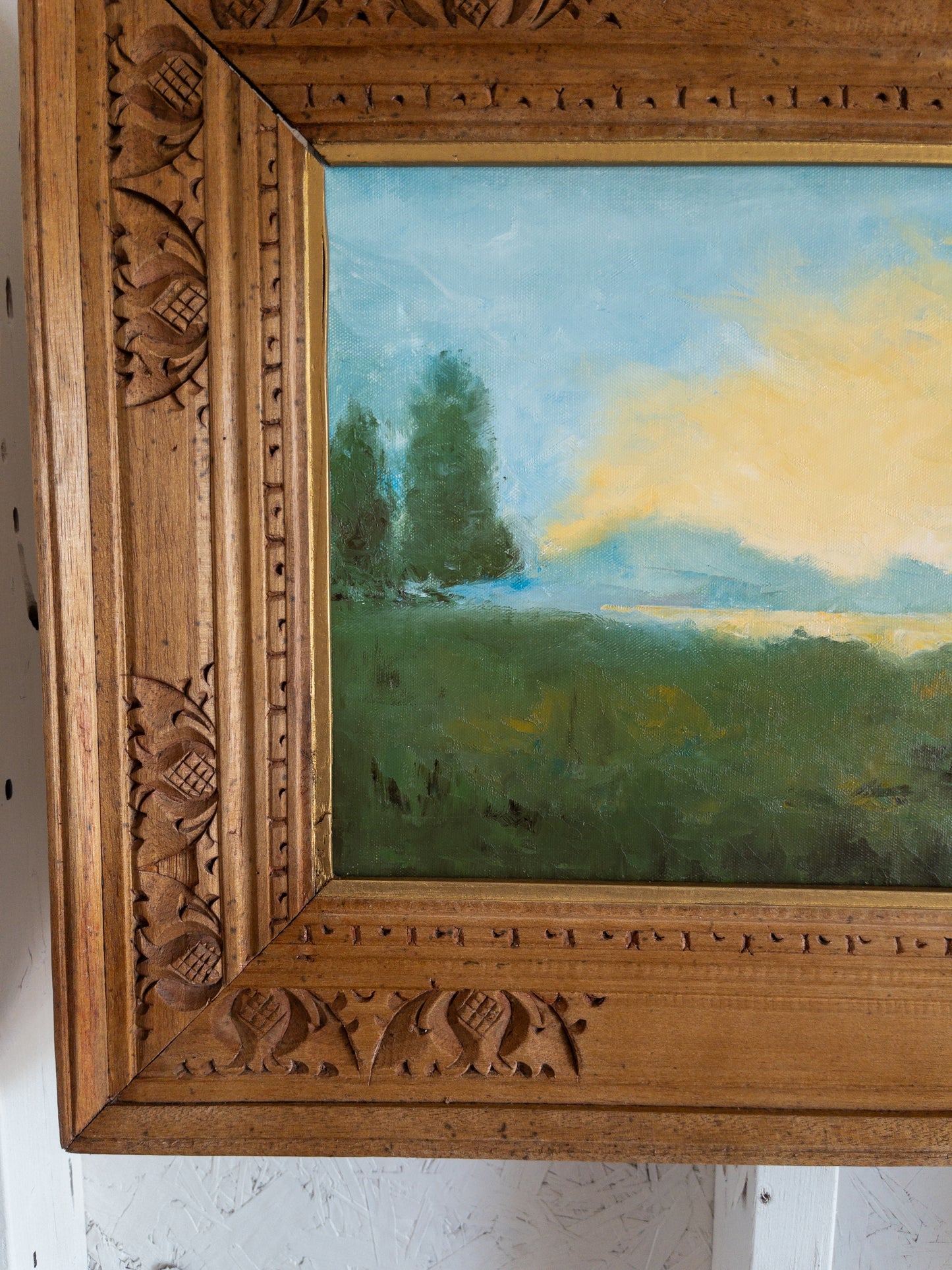 landscape painting in hand carved frame